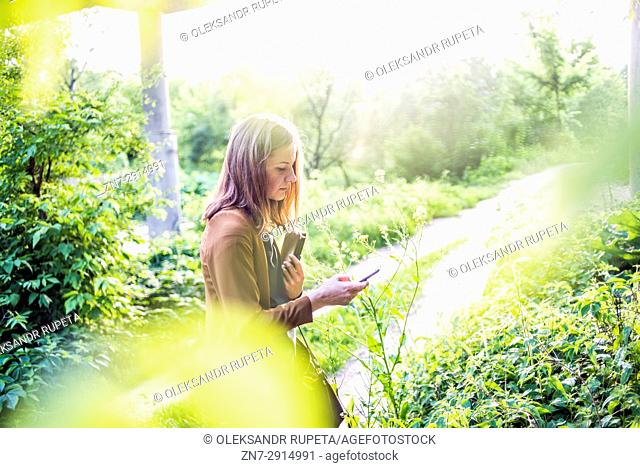Woman looking at mobile phone outdoors