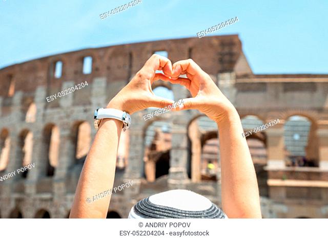 Woman Making Heart Shape In Front Of Colosseum, Italy