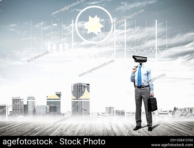 Elegant businessman outdoors holding jacket on shoulder and camera instead of his head