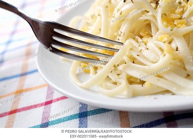 closeup of a plate of pasta on a checkered tablecloth