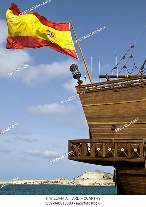 Spanish flag flying on 17th Century Spanish Armada galleon berthed at the Grand Harbour in Malta