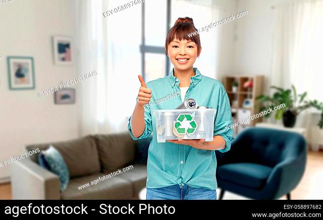 smiling young asian woman sorting metallic waste