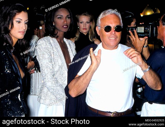 Italian fashion designer Giorgio Armani with some models. 1990s