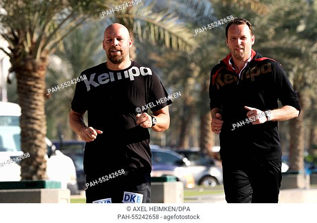 Germany's headcoach Dagur Sigurdsson (r) and Germany's assistant coach Axel Kromer are jogging along the skyline of Doha during the men's Handball World...