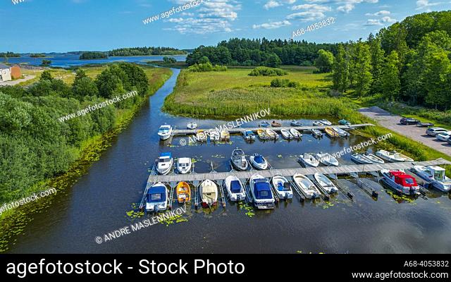 Leisure boats in the harbor at Karlholmsbruk in Uppland. . A long channel is dredged to get in and out.