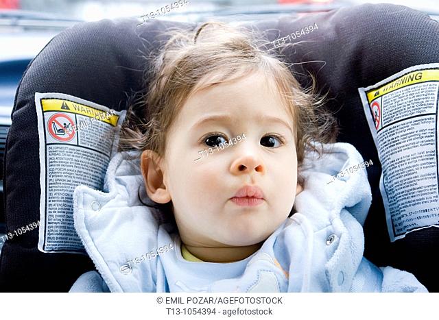Eight month old infant boy in a car portrait