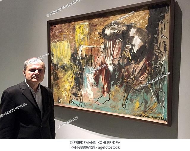 Berlin art historian Eckhart Gillen standing next to the painting ""Three months after the war"" by Eli Belyutin of the Soviet Union 1945