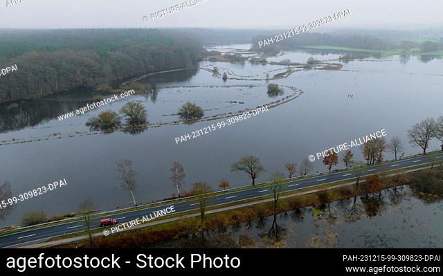15 December 2023, Lower Saxony, Deutsch Evern: The Ilmenau has flooded adjacent meadows (photo taken with a drone). After persistent rainfall and thawing...