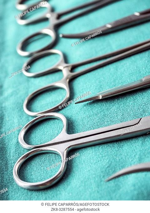 Some scissors for surgery on a tray in an operating theater, conceptual image