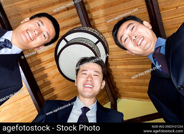 Low Angle Portrait of Three Businessmen