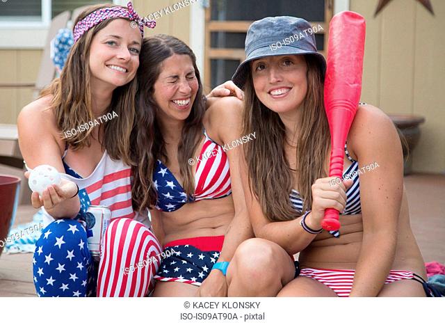 Portrait of three young women wearing American flag costume celebrating Independence Day, USA