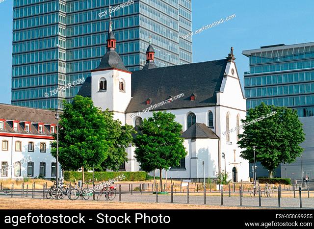 Old church and monastery St. Heribert in front of a modern office building, Cologne, Germany