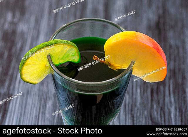 Close up of a mixture of spirulina, apple and lemon in a glass