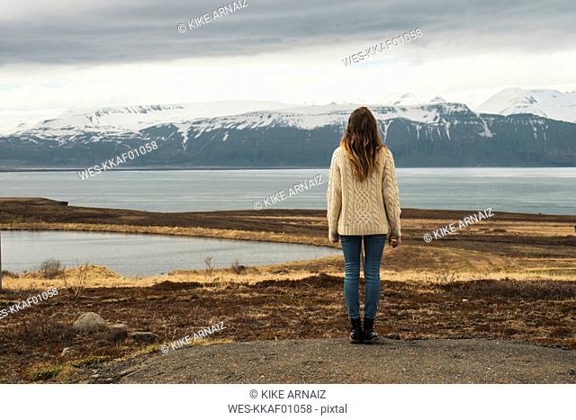 Iceland, woman standing at lakeside