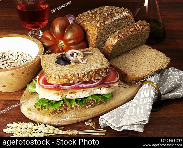 homemade chicken and vegetables wholemeal bread sandwich with ingredients in wood table background