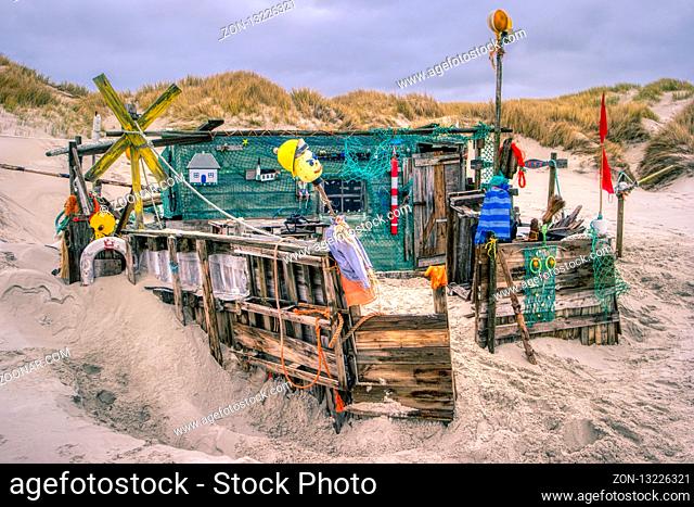 AMRUM, GERMANY - DECEMBER 28, 2018: On the Kniepsand Beach of the North Frisian Island Amrum in Germany Land-Artists made Beach Huts and other Objects out of...