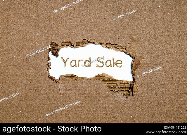 The word yard sale appearing behind torn paper