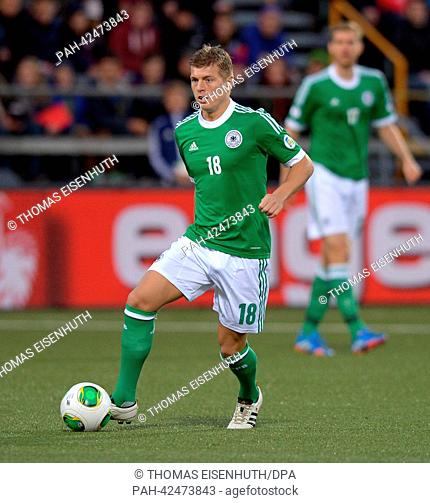 Germany's Toni Kroosg plays the ball during the FIFA World Cup 2014 qualification group C soccer match between the Faroe Islands and Germany at the Torsvollur...