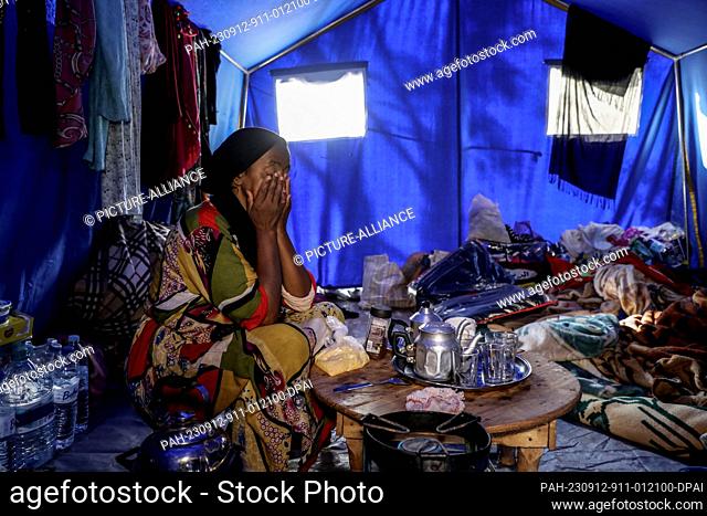 12 September 2023, Morocco, Al Haouz: Saiida, 54 years old, cries her mother's death inside a tent at a temporary Moroccan civil protection camp that was set up...