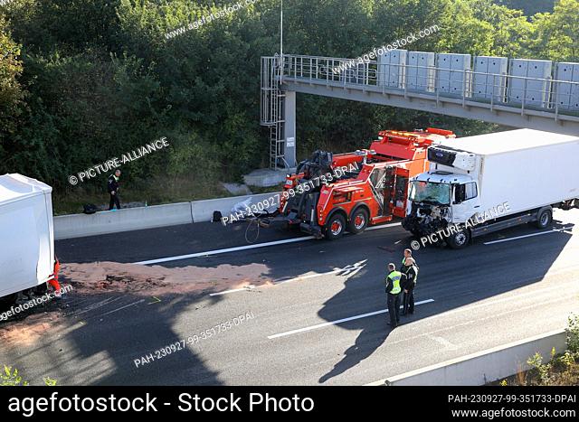 27 September 2023, Hamburg: Badly damaged trucks stand after an accident on the A7 freeway heading north. In a rear-end collision involving three trucks on the...