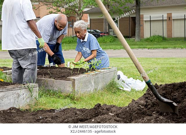 Detroit, Michigan - Members of St. John's Presbyterian Church plant a community garden