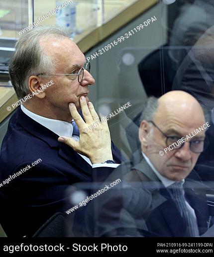16 September 2021, Saxony-Anhalt, Magdeburg: Reiner Haseloff (CDU, l), Executive Minister-President of Saxony-Anhalt, reacts after the announcement of the...