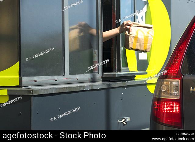 Stockholm, Sweden An attendant hands over food at a Mc Donald's drive-thru window