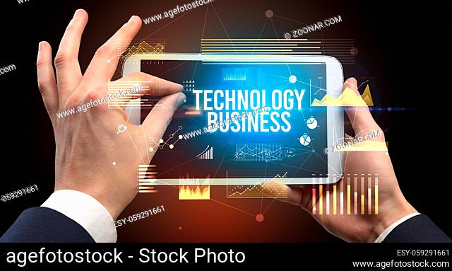 Close-up of hands holding tablet with SHARING ECONOMY inscription, modern business concept