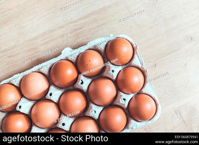 Top view of chicken eggs in a basket
