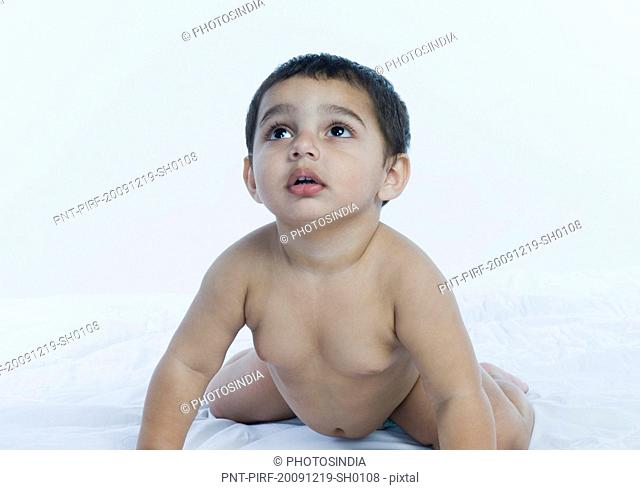 Baby boy crawling on the bed