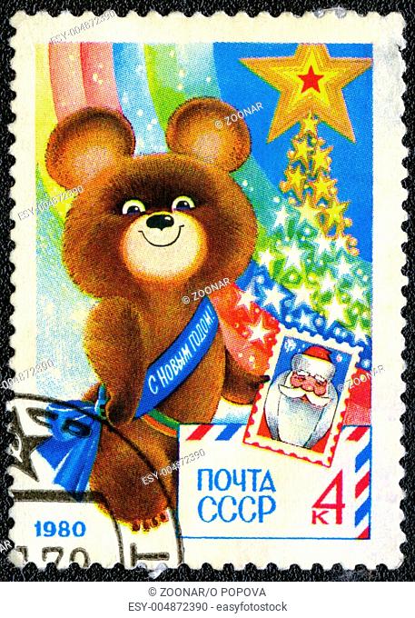USSR - CIRCA 1979: A stamp printed in USSR shows Olympic Bear Holding Stamp - a symbol of the Moscow Olympics games, New Year 1980