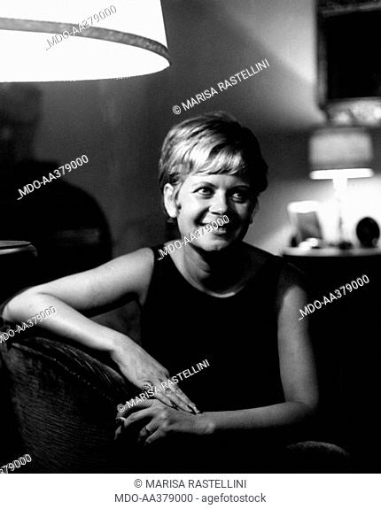 Lianella Carell sitting on a couch. Italian actress and journalist Lianella Carell sitting on a couch. Rome, 1963