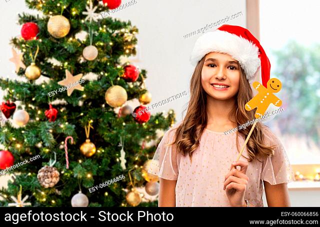happy teenage girl in santa hat on christmas