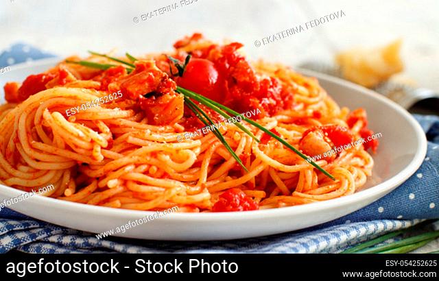 Spaghetti alla amatriciana on a wooden table top view