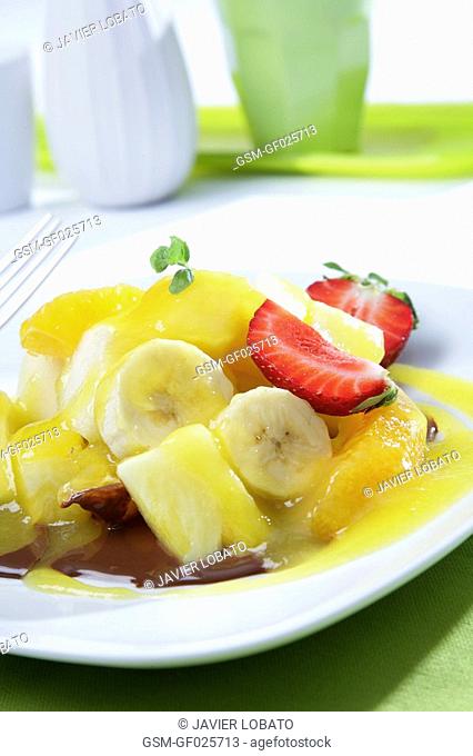 Seasonal fruits with mango juice and hot chocolate sauce