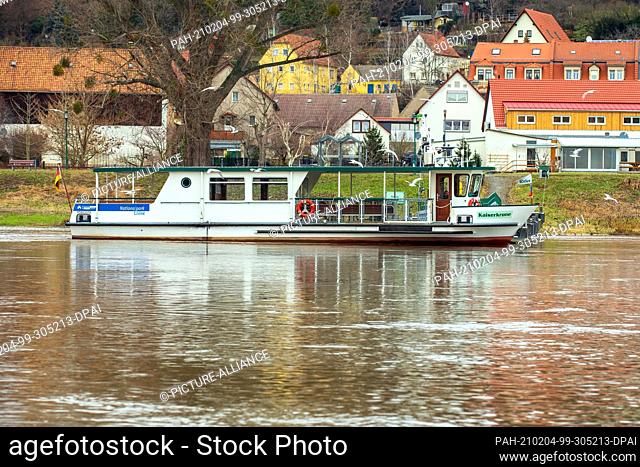 03 February 2021, Saxony, Pirna: The ferry Kaiserkrone, which belongs to the local public transport (PNV) in Pirna, waits at the pier on the east bank