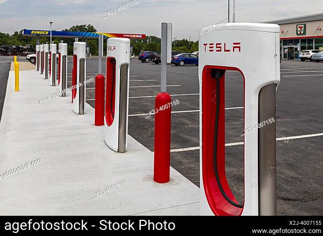 Elkhart, Indiana - Charging stations for Tesla electric vehicles next to a Sunoco gas station on the Indiana Toll Road