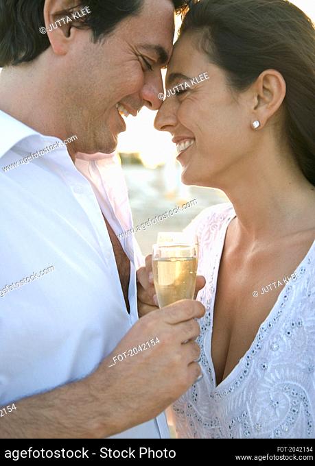 Couple on Beach Toasting with Champagne