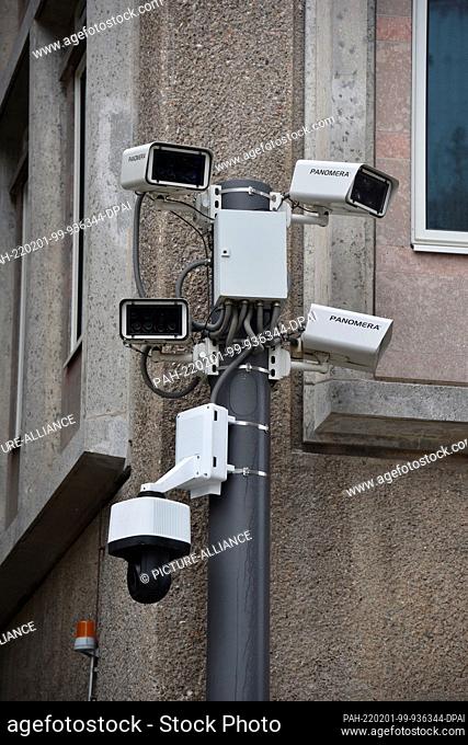 01 February 2022, North Rhine-Westphalia, Cologne: Cameras for video surveillance on a house wall next to an alley on the forecourt of the Cologne Cathedral...