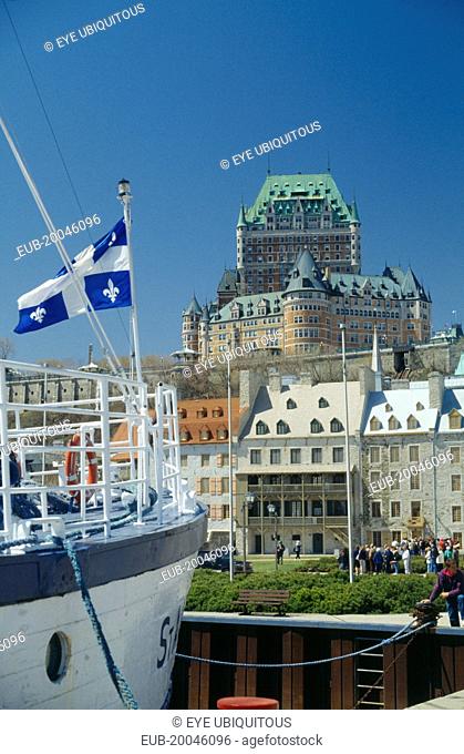 View of the Chateau Frontenac seen from moored boat flying the Quebec Flag