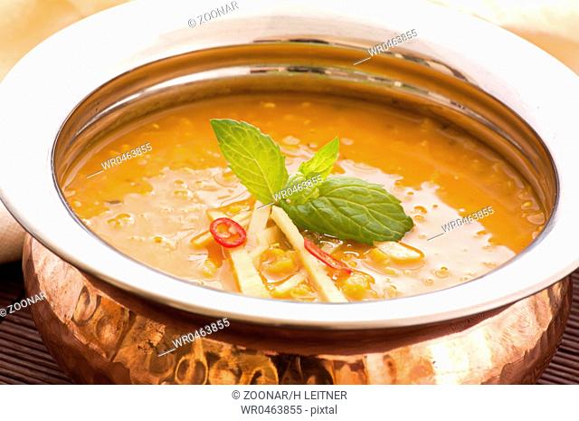 Lentil soup in a brass bowl as closeup