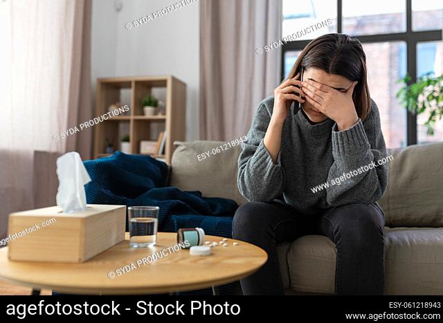 stressed woman with medicine calling on phone