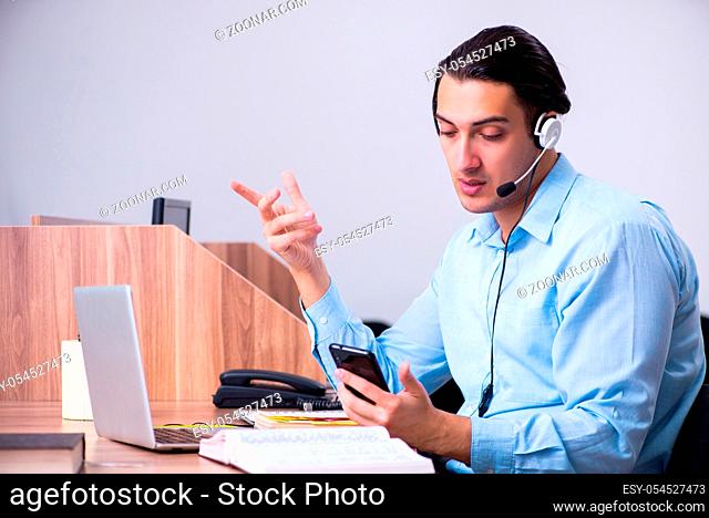 The call center operator working at his desk