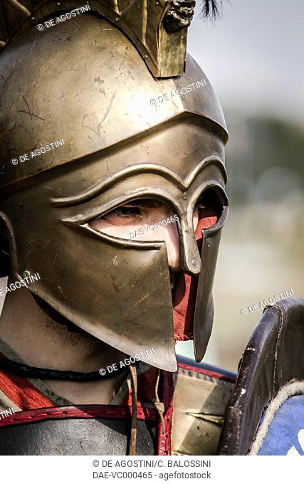 Ancient Greek warrior wearing a Corinthian helmet. Historical reenactment