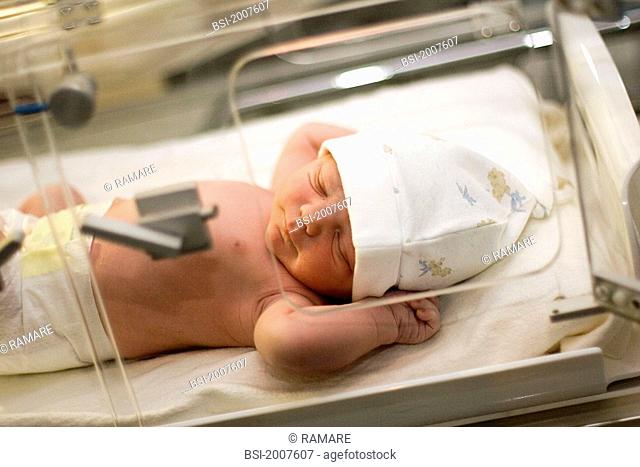 NEWBORN BABY Photo essay from hospital. The newborn baby sleeps in an incubator that maintain a constant temperature. We can see the traces of the antibiotic...