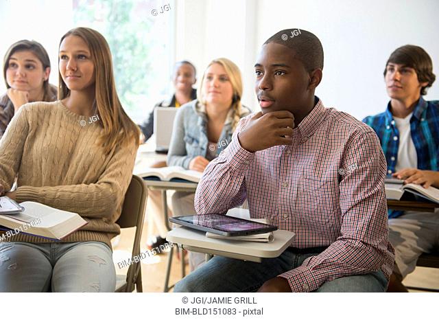 Teenage students listening in classroom