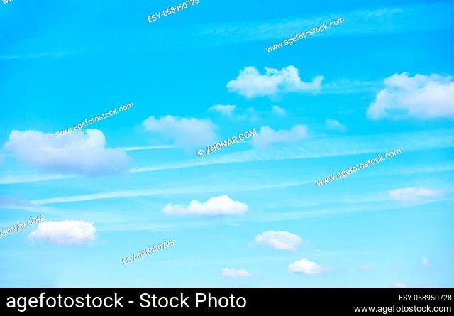 Pastel blue sky small clouds - background with space for your own text