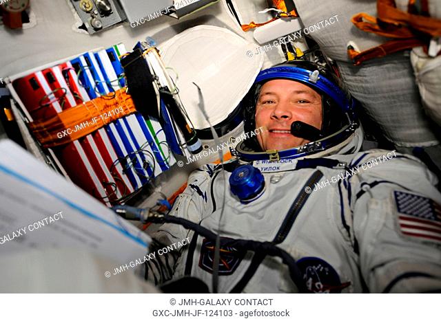 NASA astronaut Doug Wheelock, Expedition 24 flight engineer, attired in his Russian Sokol launch and entry suit, occupies his seat in the Soyuz TMA-19...