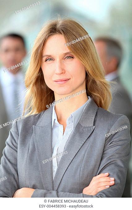 Closeup of blond businesswoman standing outside