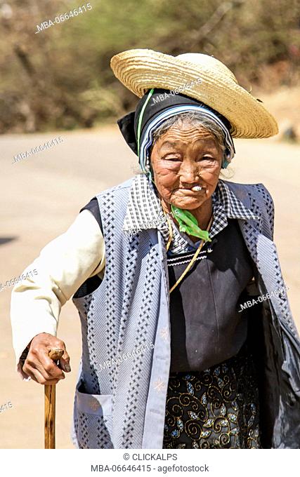 Old Chinese woman dressed with traditional Bai clothing during the Heqing Qifeng Pear Flower festival, China